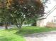 Brick house with a healthy green lawn and mature trees offering shade and curb appeal at 2447 Omaha Sw Rd, Atlanta, GA 30331