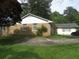 Cozy brick home with a well-maintained lawn and a concrete driveway leading to the side of the house at 2447 Omaha Sw Rd, Atlanta, GA 30331