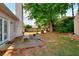 The backyard features a patio, lush greenery and mature trees for shade and privacy at 2465 Planters Cove Cir, Lawrenceville, GA 30044