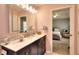 Stylish bathroom featuring a marble countertop, dark vanity, and decorative mirror at 2465 Planters Cove Cir, Lawrenceville, GA 30044