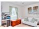 Bright bedroom featuring natural light, a white sofa, and a decorative bookshelf at 2465 Planters Cove Cir, Lawrenceville, GA 30044