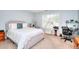 Serene main bedroom with plush carpeting, large window, and neutral color scheme at 2465 Planters Cove Cir, Lawrenceville, GA 30044