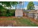 A storage shed sits against a wooden fence in the spacious backyard, adding to the property's appeal at 2465 Planters Cove Cir, Lawrenceville, GA 30044