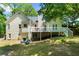Exterior of home showing a deck with white railings overlooking a spacious, green backyard at 5640 Rolling Oaks Dr, Cumming, GA 30040