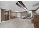 Spacious basement with carpet and drop ceiling ready to be finished with a doorway and several boxes at 5640 Rolling Oaks Dr, Cumming, GA 30040
