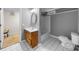 A bathroom with tile flooring and a wooden vanity; next to the bathroom is a carpeted room at 5640 Rolling Oaks Dr, Cumming, GA 30040