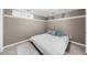 Neutral bedroom with a large bed with white bedding, grey and blue decorative pillows and a rug at 5640 Rolling Oaks Dr, Cumming, GA 30040