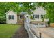 Charming home with stone accents, light siding, and a well-maintained front yard with trees at 5640 Rolling Oaks Dr, Cumming, GA 30040