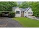 Charming home with a well-manicured lawn, a carport, and a stone chimney with great curb appeal at 5640 Rolling Oaks Dr, Cumming, GA 30040