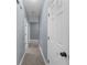 A bright hallway features neutral carpet, light gray walls, and white doors that add a touch of simple elegance at 5640 Rolling Oaks Dr, Cumming, GA 30040