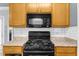 A well-equipped kitchen with a gas range and built-in microwave for cooking convenience at 5640 Rolling Oaks Dr, Cumming, GA 30040