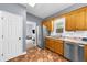 View of kitchen with stainless steel appliances, window and tile flooring at 5640 Rolling Oaks Dr, Cumming, GA 30040