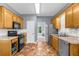 Galley kitchen features stainless appliances, subway tile backsplash, and warm wood cabinets at 5640 Rolling Oaks Dr, Cumming, GA 30040