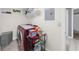 Functional laundry area with washer, shelving, and window, with a doorway leading to another room at 5640 Rolling Oaks Dr, Cumming, GA 30040