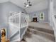 Second view of the living room showcasing the vaulted ceiling, fireplace, and staircase at 5640 Rolling Oaks Dr, Cumming, GA 30040