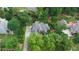 Stunning aerial view of the home with mature trees, a driveway, and well-maintained landscaping at 4645 Waterford Dr, Suwanee, GA 30024