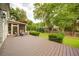 Wide angle view of back deck with comfortable seating, well-maintained yard, and lush landscaping at 4645 Waterford Dr, Suwanee, GA 30024