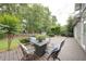Outdoor back deck with chairs, table and pleasant backyard views at 4645 Waterford Dr, Suwanee, GA 30024