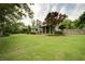 A beautifully landscaped backyard with a large lawn and mature trees at 4645 Waterford Dr, Suwanee, GA 30024