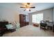 Bedroom featuring a ceiling fan, bookshelf, desk, large window, and neutral-colored carpet at 4645 Waterford Dr, Suwanee, GA 30024