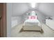 Bonus room featuring a full sized bed, carpet, dresser, ceiling light, and slanted ceilings at 4645 Waterford Dr, Suwanee, GA 30024