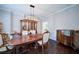 Elegant dining room with hardwood floors and classic chandelier lighting at 4645 Waterford Dr, Suwanee, GA 30024
