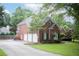 Beautiful brick home featuring a three-car garage and well-maintained landscaping at 4645 Waterford Dr, Suwanee, GA 30024