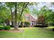 Charming brick home with a well-manicured lawn, mature trees, and beautiful landscaping at 4645 Waterford Dr, Suwanee, GA 30024