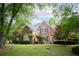 Charming brick home with lush landscaping, mature trees and a well-manicured lawn at 4645 Waterford Dr, Suwanee, GA 30024