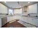 This kitchen offers white cabinets, granite countertops, stainless steel appliances, and a gas cooktop at 4645 Waterford Dr, Suwanee, GA 30024
