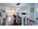 Bright eat-in kitchen boasts an island with seating, granite countertops, modern appliances, and hardwood floors at 4645 Waterford Dr, Suwanee, GA 30024