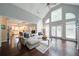 Bright living area featuring a vaulted ceiling, large windows, and hardwood flooring at 4645 Waterford Dr, Suwanee, GA 30024