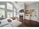 Bright living area with a cozy fireplace, hardwood floors, and access to outdoor light at 4645 Waterford Dr, Suwanee, GA 30024