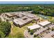 Wide aerial view of school buildings featuring athletic fields, parking lots and green spaces at 7045 Grand View Way, Suwanee, GA 30024