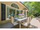Back deck with patio dining set, large windows, and a view of the landscaped backyard. Great for entertaining at 7045 Grand View Way, Suwanee, GA 30024
