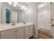 Bathroom featuring double sinks, white cabinetry, and a shower with a tub at 7045 Grand View Way, Suwanee, GA 30024