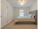 Bright bedroom featuring neutral tones, a ceiling fan, and a comfortable-looking bed with stylish patterned comforter at 7045 Grand View Way, Suwanee, GA 30024