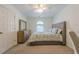 Well-lit bedroom with a bed, dresser, and a window providing natural light at 7045 Grand View Way, Suwanee, GA 30024