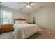 Spacious bedroom with carpet and classic wooden furniture at 7045 Grand View Way, Suwanee, GA 30024