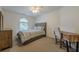 Comfortable bedroom featuring neutral tones, a ceiling fan, and a large window at 7045 Grand View Way, Suwanee, GA 30024