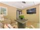 Covered patio with outdoor seating and a TV for entertaining with views of the landscaped backyard at 7045 Grand View Way, Suwanee, GA 30024
