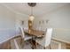 Elegant dining room features a chandelier, crown molding, and a wooden table with seating for four at 7045 Grand View Way, Suwanee, GA 30024