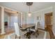 Elegant dining room features a chandelier, crown molding, and a wooden table with seating for four at 7045 Grand View Way, Suwanee, GA 30024