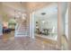Elegant foyer with staircase, columns, marble flooring, and views of the dining room and living room at 7045 Grand View Way, Suwanee, GA 30024