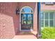 Inviting entryway featuring a double front door, brick facade, and decorative wreath accents at 7045 Grand View Way, Suwanee, GA 30024
