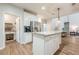 Bright kitchen with white cabinets, granite countertops, stainless steel appliances and a kitchen island at 7045 Grand View Way, Suwanee, GA 30024