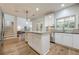 Bright kitchen with white cabinets, granite countertops, stainless steel appliances and a kitchen island at 7045 Grand View Way, Suwanee, GA 30024