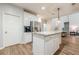 Bright kitchen with white cabinets, granite countertops, stainless steel appliances and a kitchen island at 7045 Grand View Way, Suwanee, GA 30024