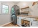 Laundry room with stacked washer and dryer, butcher block countertop and shelving at 7045 Grand View Way, Suwanee, GA 30024