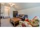 Living area with vaulted ceilings, a leather sofa, TV, and a desk area at 7045 Grand View Way, Suwanee, GA 30024